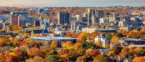 Downtown New Haven, Connecticut skyline in autumn, highlighting the walkable urban core and public transit connections in the city.