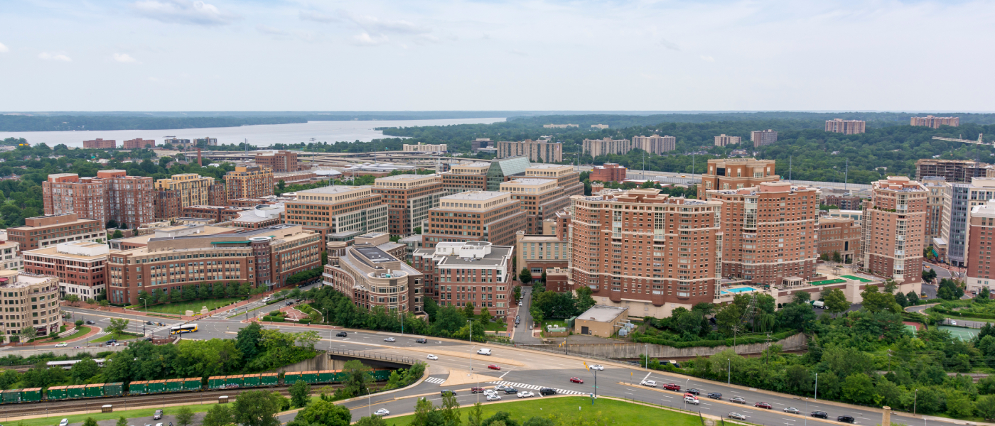 Aerial view of Alexandria, VA showing apartment buildings, major roadways, and the Potomac River, highlighting the city's connectivity and Alexandria public transit access for renters.
