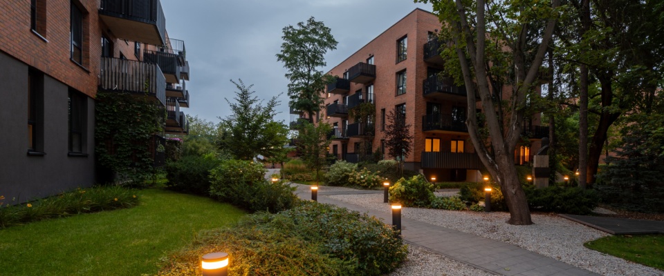 Lighting system lit up in the evening in the yard of a community of downtown apartments.