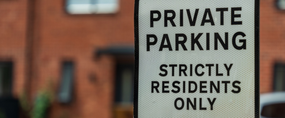 A "Private parking" sign.