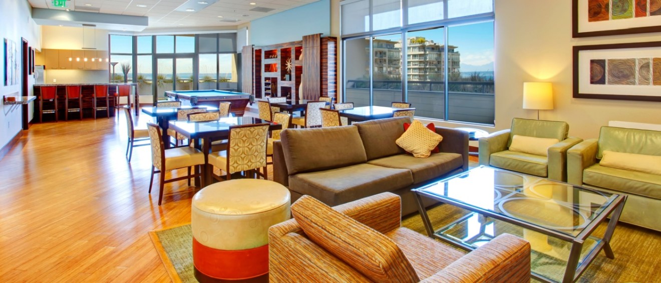 Residential club rooms featuring a billiards table and lounge seating area, designed for relaxation and socializing within the building.