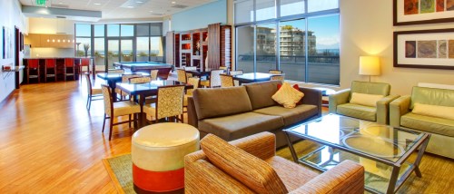 Residential club rooms featuring a billiards table and lounge seating area, designed for relaxation and socializing within the building.