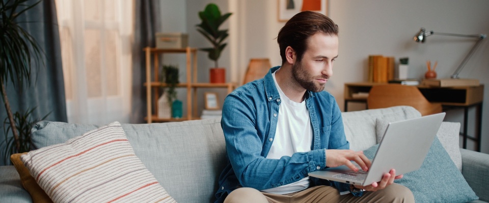 A person uses a laptop to check their lease renewal agreement.