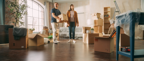 happy couple moving in a new rental apartment