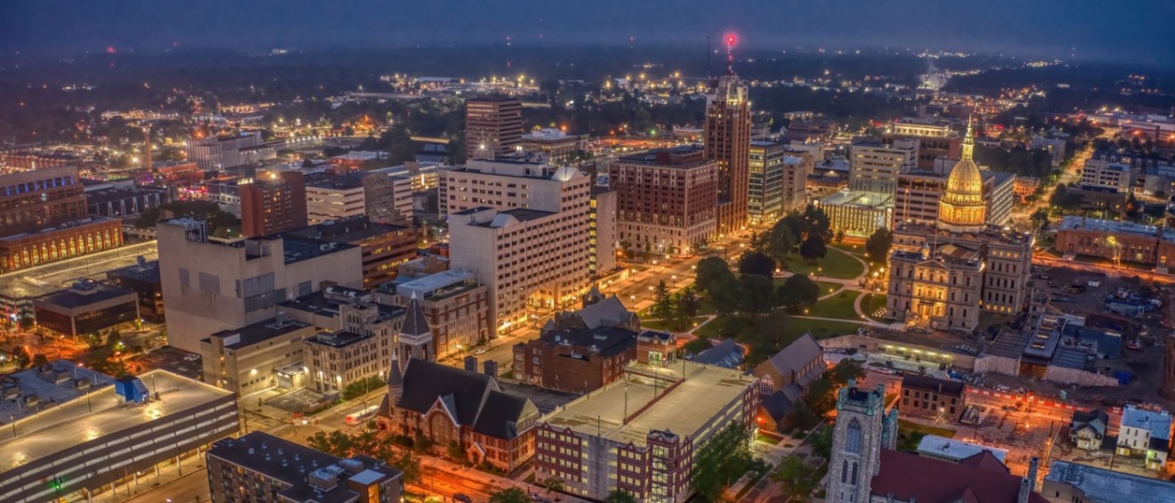 A nighttime view of Lansing, MI, a city where renters have plenty of public transportation options.