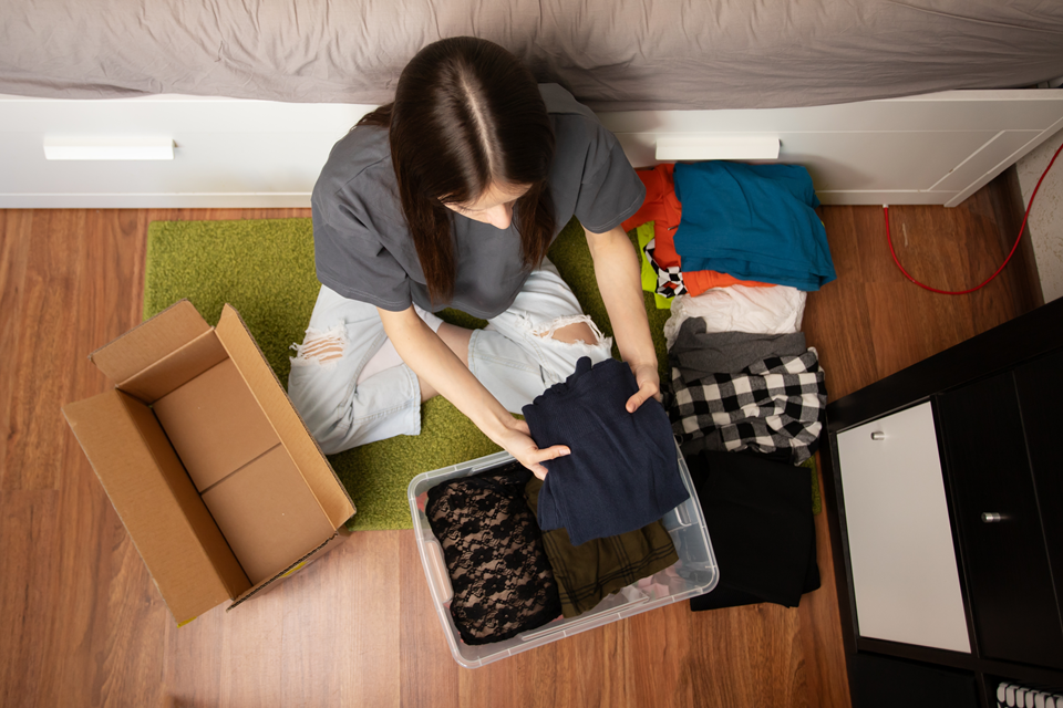 young woman unpacking in new apartment