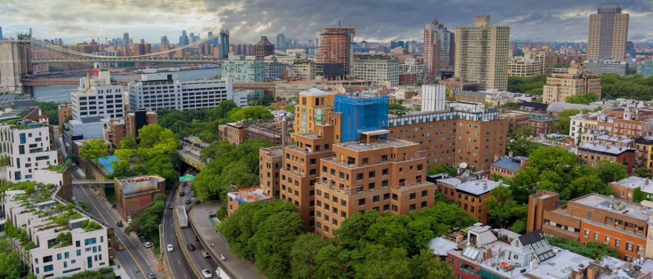 An aerial view of Brooklyn and Brooklyn Bridge to illustrate questions to ask before renting an apartment in Brooklyn, NY.