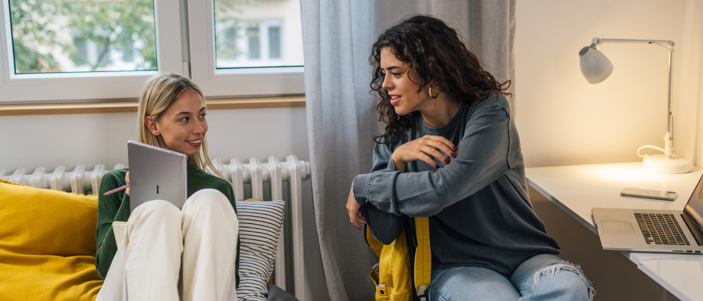 Two people talking after finishing their college apartment search.