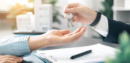 agent handing keys to new renter