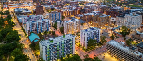 Aerial dusk view of affordable neighborhoods in St. Louis, MO featuring mid-rise apartment buildings and tree-lined streets.