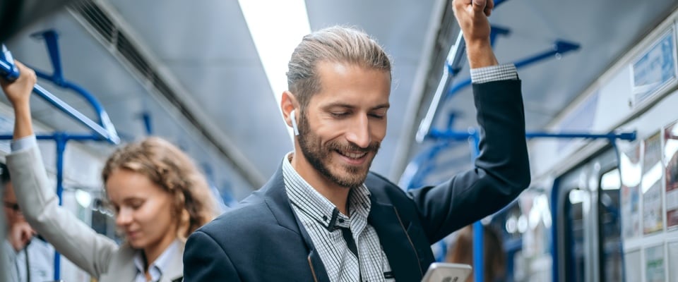 Business professional commuting on a subway train, illustrating access to transit and convenience when choosing the right neighborhood for a young professional.
