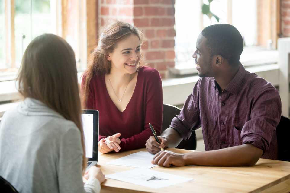 image of a happy couple signing a lease agreement for a new rental apartment