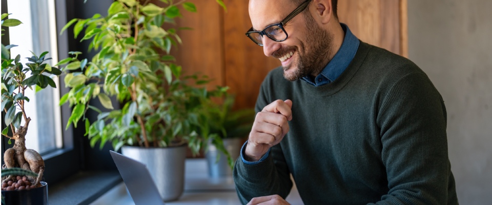 Young professional speaking during a video conference call, representing remote work flexibility and career-focused living in the right neighborhood for a young professional.