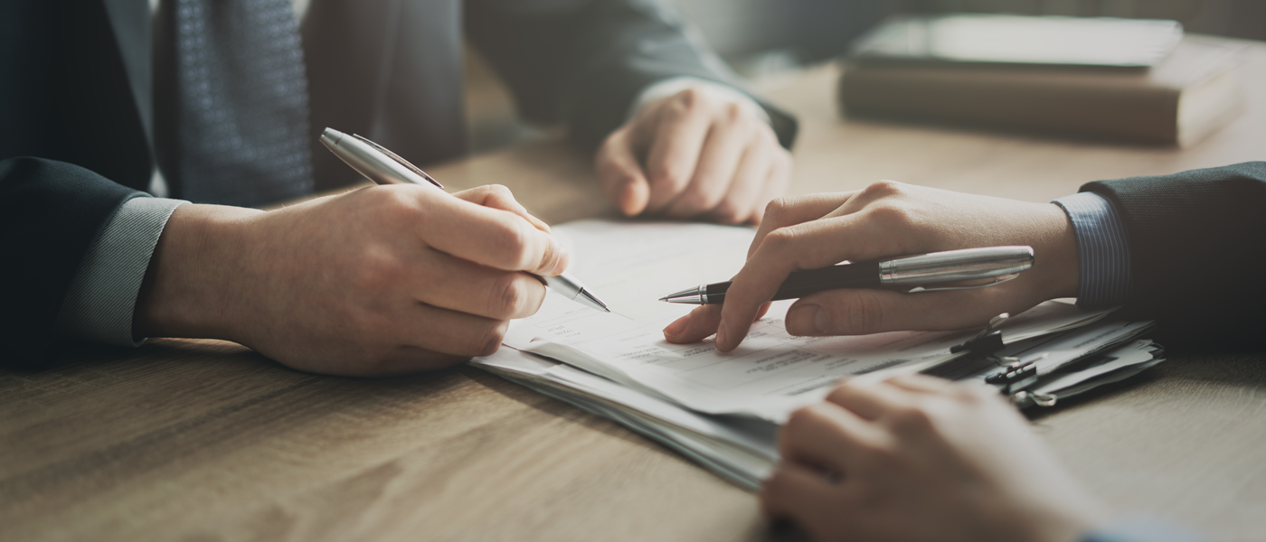 close up of contract and people's hands when discussing and signing