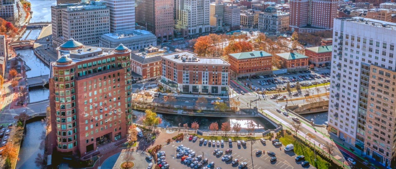 Aerial view of Providence, Rhode Island at sunset, highlighting urban connectivity and public transit access throughout the city.