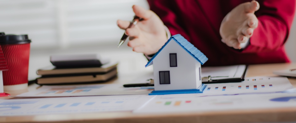 Real estate agent assisting a family with signing rental documents, representing lease renewal season and important housing decisions for residents.