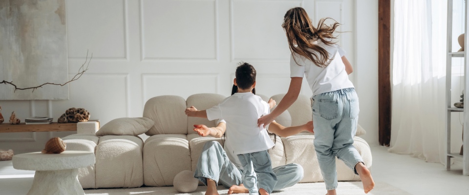 Two children playing together in a bright, spacious living room, illustrating the family-friendly homes and everyday experiences of millennial renters with kids.