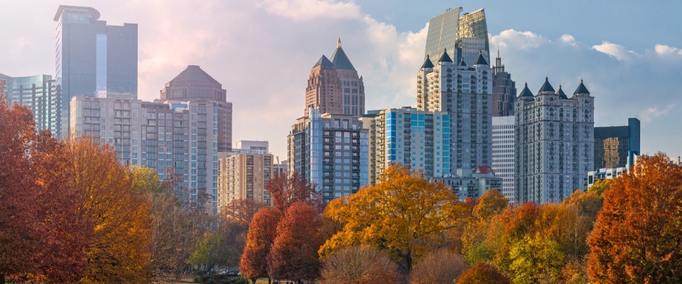 Best cities for renters highlighted by the Atlanta skyline viewed from Piedmont Park, showcasing green spaces, modern skyscrapers, and a vibrant urban lifestyle.