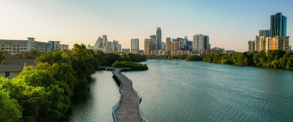 Best cities for renters highlighted by an aerial view of Austin, Texas, showcasing the downtown skyline, the Colorado River, and the city's blend of urban living and outdoor spaces.