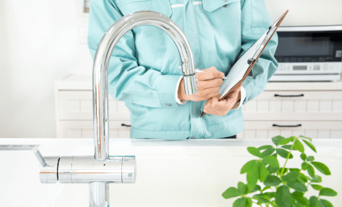 person checking water pressure before renting an apartment