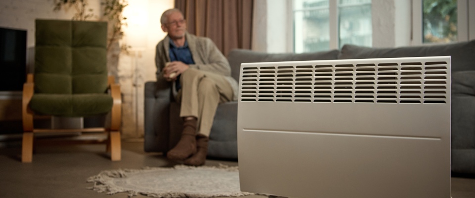 Modern living room with an electric convector heater, highlighting energy-efficient heating, indoor comfort, and amenities in apartments in Asheville.