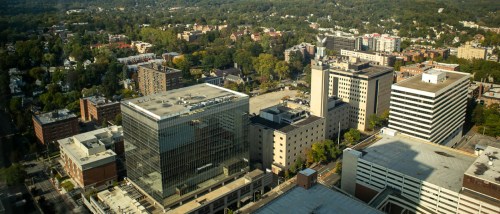Overhead shot of White Plains, NY featuring modern office towers, residential blocks, and busy streets, showcasing why public transit in White Plains makes car-free living easy for renters.