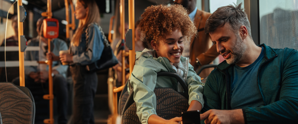 A parent and a child talking while using public transit in Trenton, NJ.
