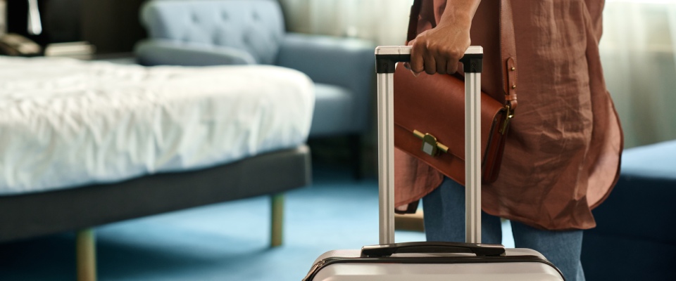 Resident entering a modern apartment with a suitcase, highlighting move-in day and the welcoming lifestyle offered by apartments in Asheville.