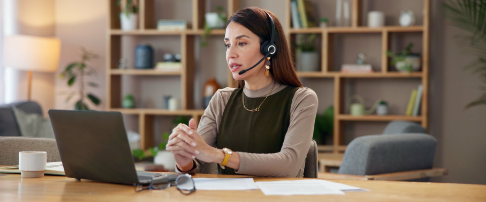 A person wearing a headset while working from home in a shared apartment.