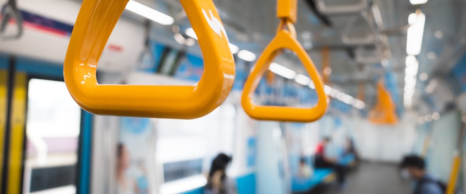A close-up of hand straps inside public transit.