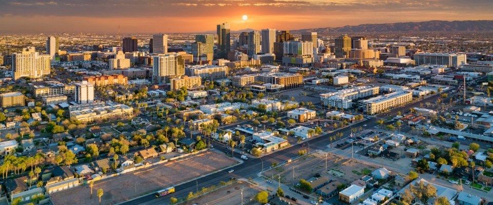 Aerial view of the Phoenix, Arizona, downtown skyline, highlighting the city's urban landscape and public transit options.