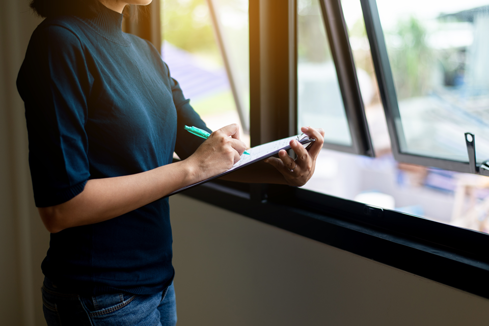 person checking the state of windows in a potential rental apartment
