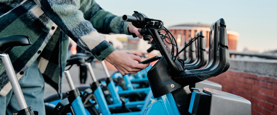 A person using a public transit bike to get around the city.