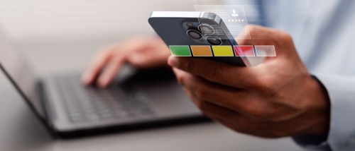 Person checking credit score information on a smartphone, illustrating how rent payment reporting data is used and protecting