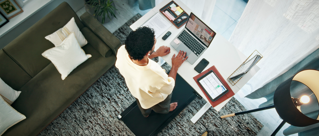 person working from home office at the desk with treadmill