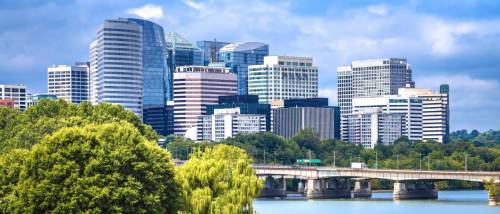 A skyline view of Arlington, Northern Virginia’s skyscrapers seen from a Washington bridge, highlighting the urban connectivity and public transit accessibility of the area.